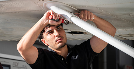 Student working on airplane