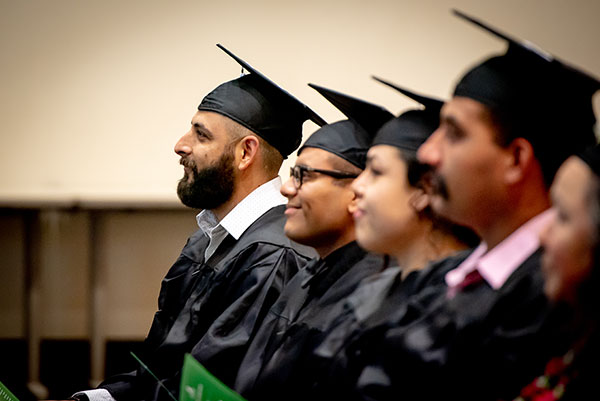 four ged students at graduation ceremony
