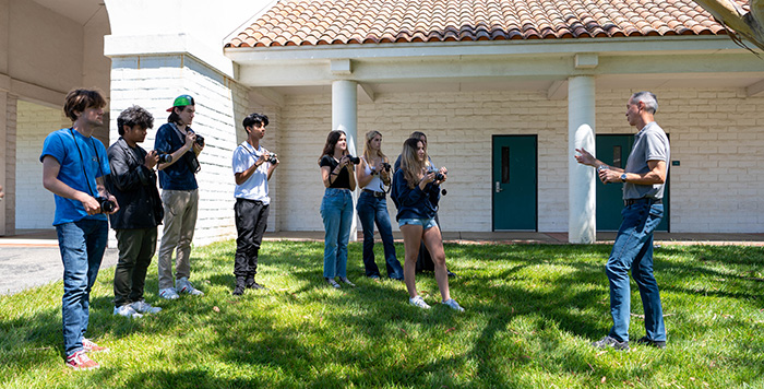 Photography professor teaching outside